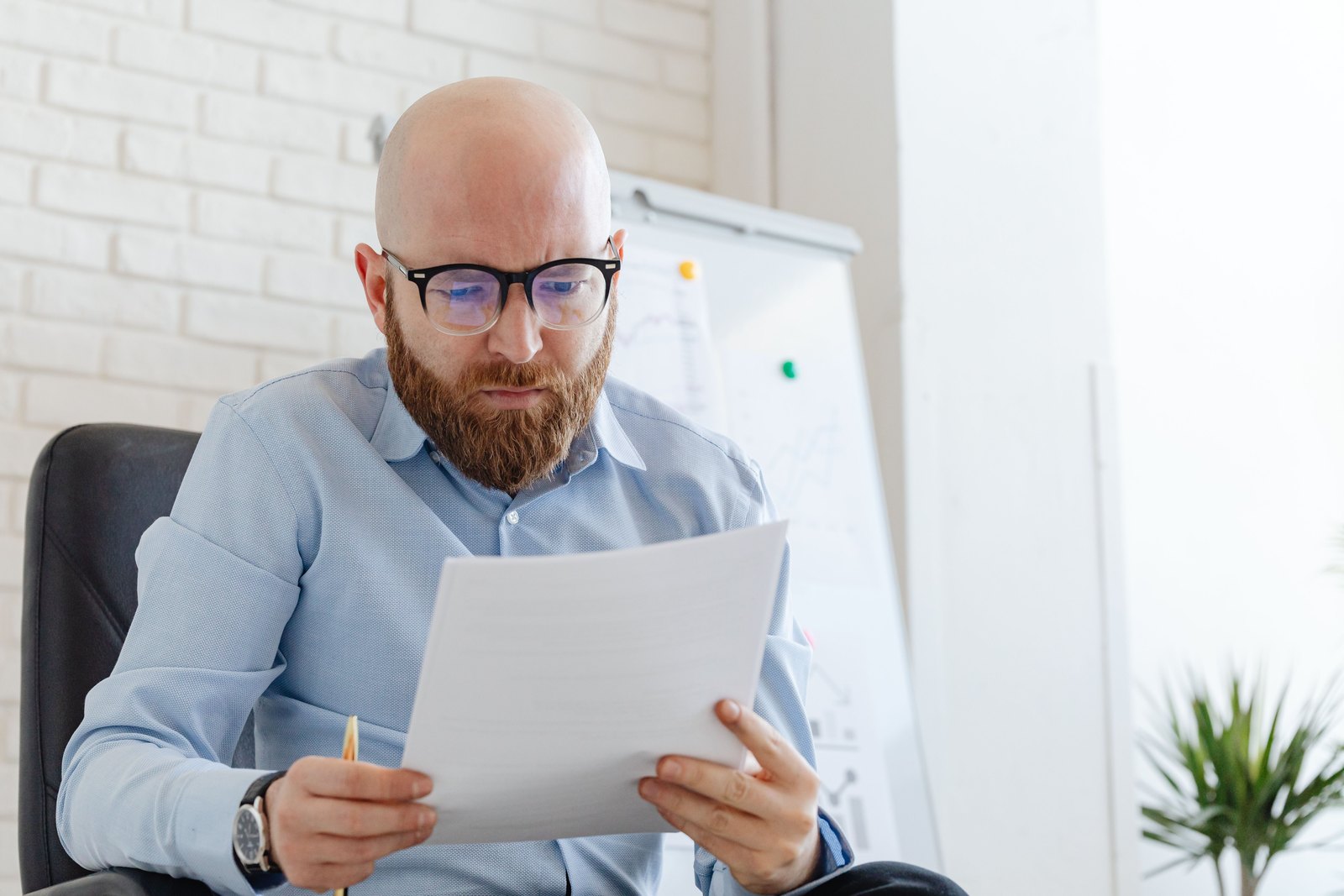 Professional carefully reviewing a printed compliance document